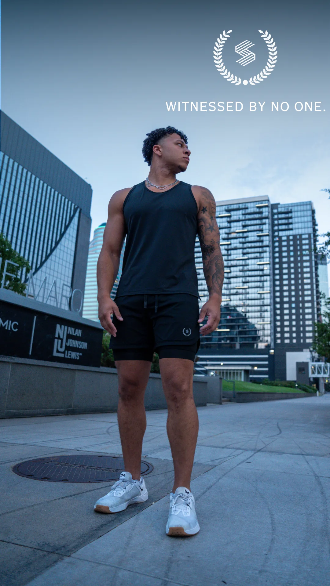 Athlete wearing the black two-layer performance shorts in an urban setting