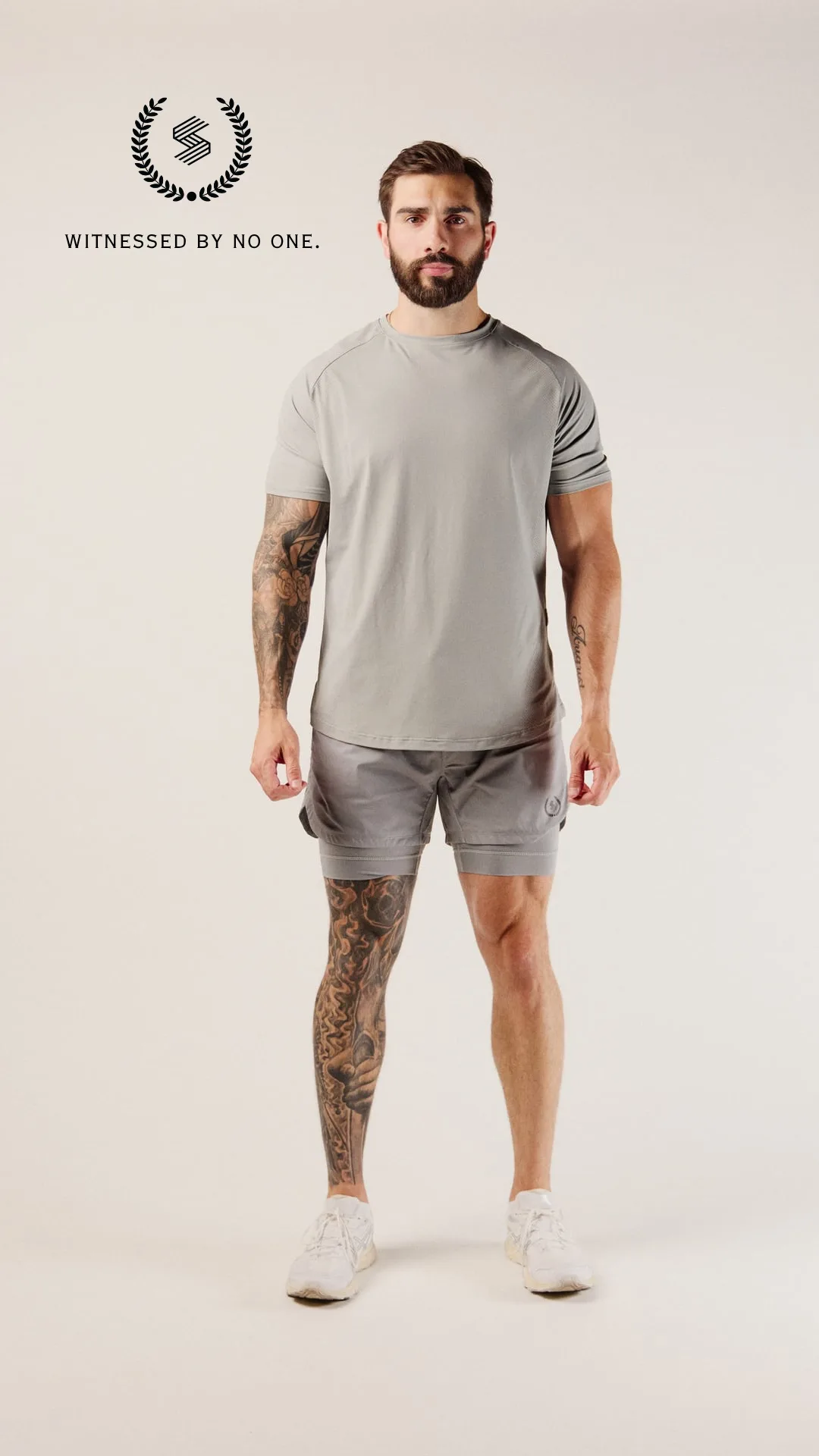 Front studio campaign photograph of the grey performance shorts